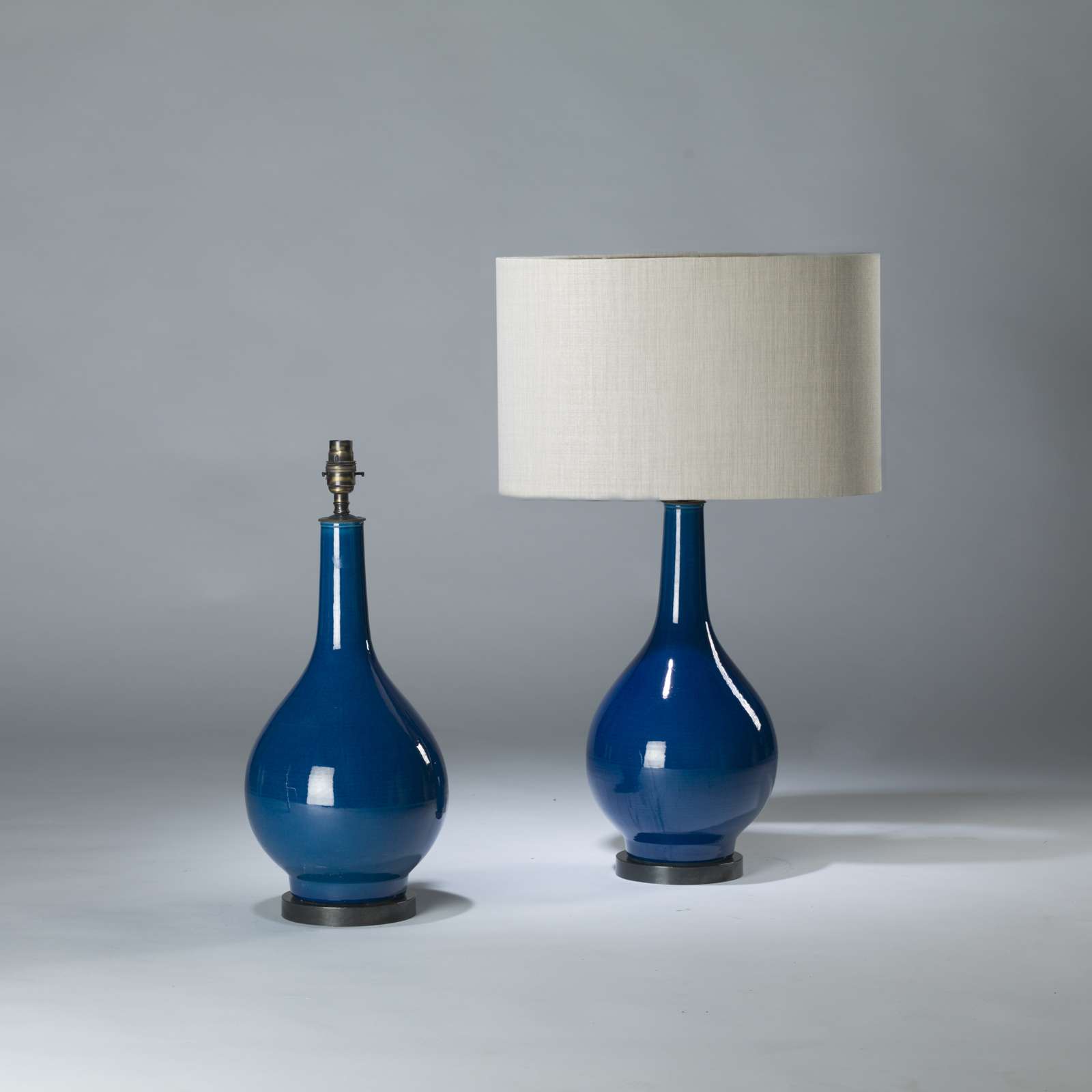 Pair Of Medium Blue Ceramic Teardrop Lamps On Round Brass Bases